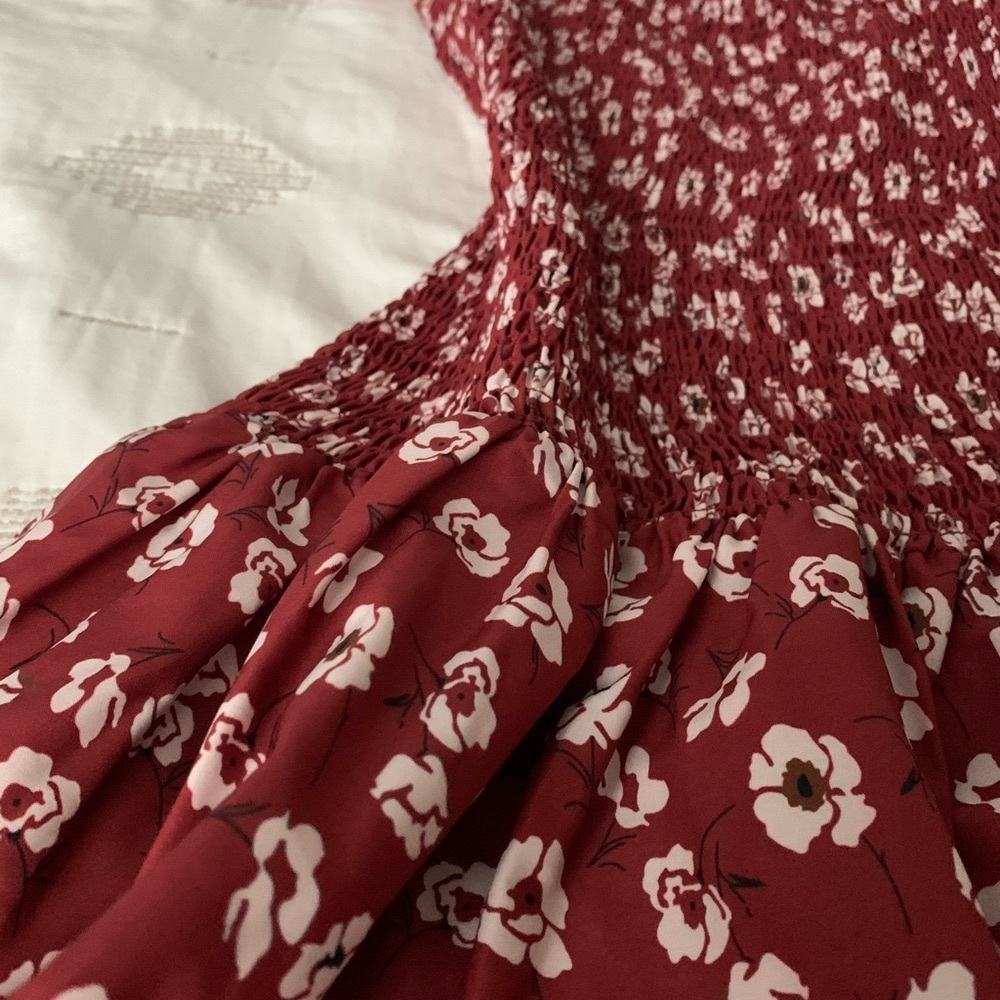 Shirred patterned mini dress with floral detail.